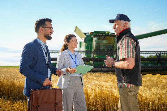 Agricultural professionals meeting with a farmer to discuss investment opportunities and farm growth strategies.