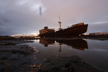 Telamon cargo shipwreck reflecting in water at dusk © Valenti