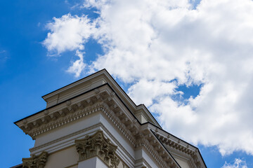 Classic architectural building facade against a bright blue sky © Serhii Bukovskyi