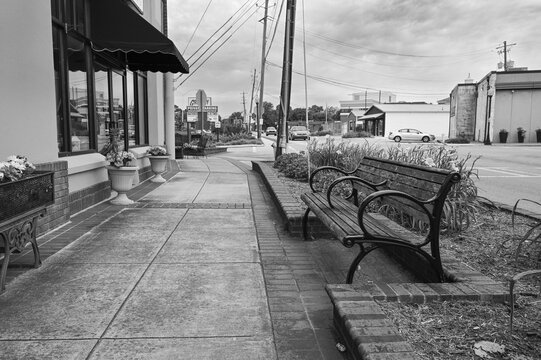 Decorative sidewalk with a bench to sit on and flower bed in Ringgold, Georgia on a cloudy day