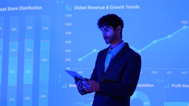 A male investment analyst presents the company's growth plan, including stock charts and computer-generated analysis of management systems, business intelligence, data statistics 