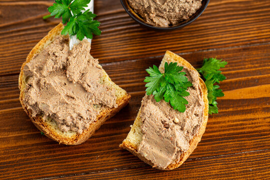 Top view of homemade pate sandwiches on brown wood
