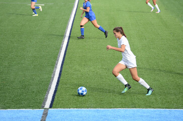 Female soccer player advancing the ball in the middle of the field © vallejo123