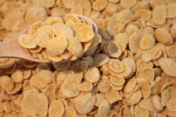 Fototapeta premium corn flakes - healthy breakfast cereal in wood spoon