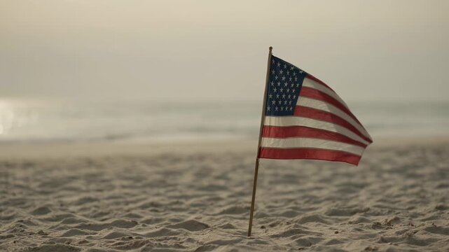 American flag waving on sandy beach