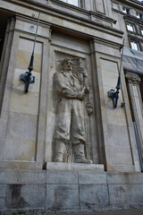 Fototapeta premium Social Realist Worker Sculpture on Historic Building Facade at Plac Konstytucji in Warsaw Poland