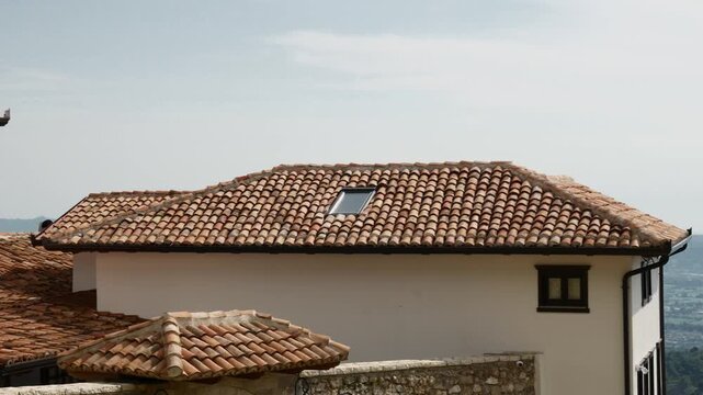 Mediterranean terracotta roof tiles on traditional house rooftop scenic architecture detail.