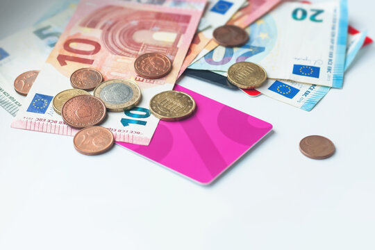Euro banknotes and coins on a light background, selective focus.