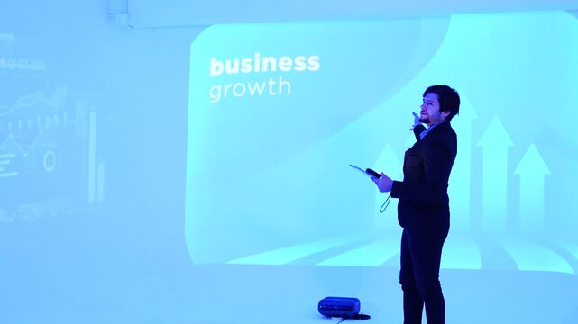 man development staff member stands in front of a conference room explaining how to use a data management system, business intelligence, data statistics, marketing analysis, and behind a slide .