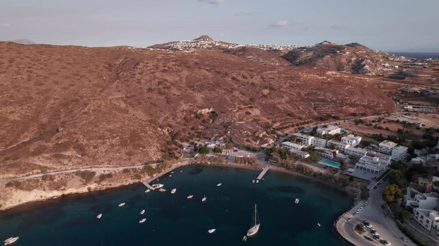 Explore secluded bay with sailboats near Parikia on Paros Island Greece with arid hills in the background