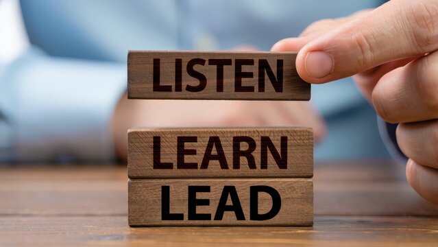 Building leadership skills with listen learn lead wooden blocks on table, workplace communication strategy, effective leadership development, personal growth mindset