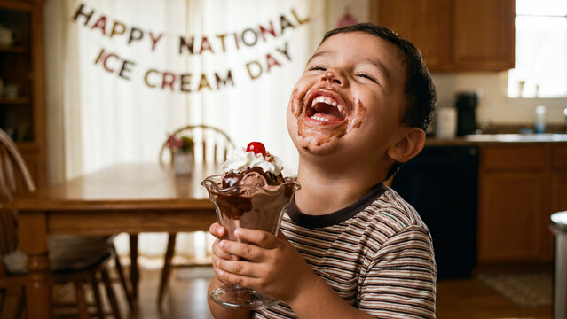National Ice Cream Day celebration with Hispanic toddler boy eating chocolate sundae for diverse summer dessert holiday marketing and promotional content