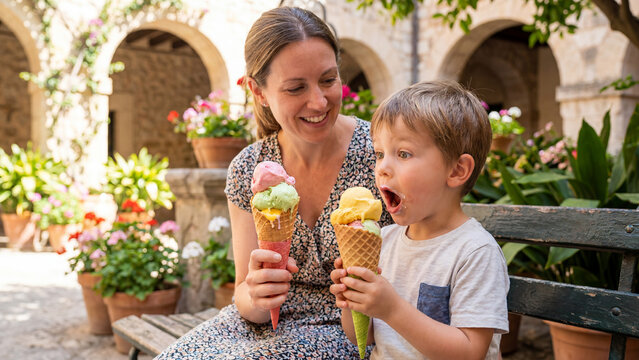 Ice cream month summer celebration family mother son eating waffle cone yard outdoor surprised joyful happy scene for poster design background banner template