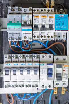 Utrecht, Netherlands - June 01, 2026: A clean, direct close-up shot of the interior rows of an electrical fuse box featuring Eaton and Holec circuit breakers and safety components.