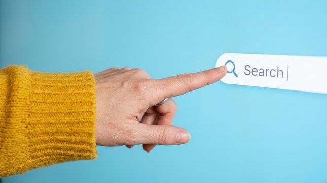 A side view of a hand in a textured yellow knit sweater pointing towards a white digital search bar with a magnifying glass icon on a solid blue wall