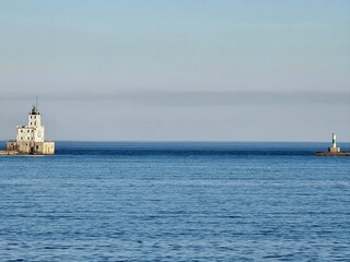 Obraz premium Lighthouse On Calm Blue Lake
