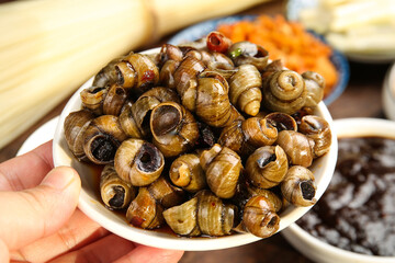 Spicy Cooked Snails Guangxi Style - Gourmet Asian Food Dish © DangThi