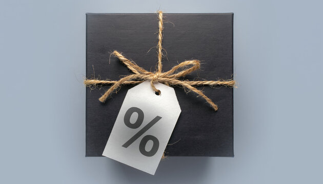 Classic black gift box securely tied with rustic natural twine and featuring a white tag displaying a clear percentage symbol for a special discount