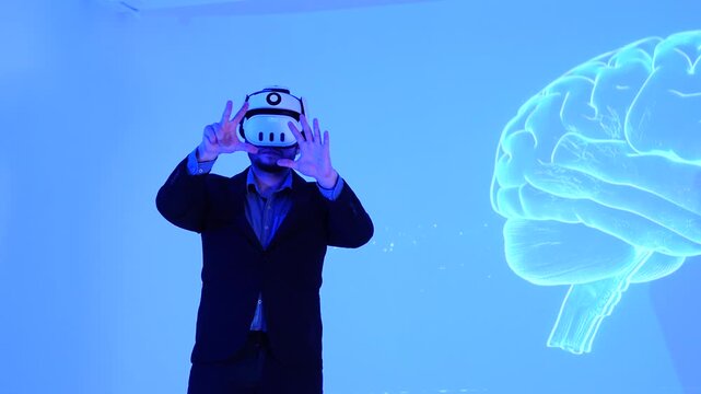 Businessman wearing virtual reality glasses demonstrates how to use a data management system, business intelligence, data statistics, marketing analysis behind a slide on a screen.