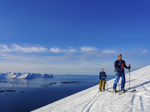 Two ski tourers on the ascent above Bergsfjord, Senja Island, Troms, Norway