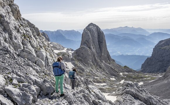 High alpine landscape, snowfields and rock, Two hikers descending from the Hochk&ouml;nig, Tyrol, Austria