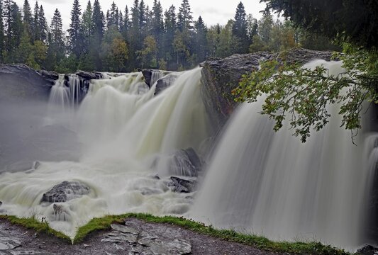 A rushing waterfall in a forest, shrouded in fine mist, autumn, Ristafallet, j&auml;mtland, Sweden