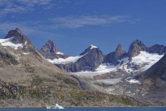 Ragged mountains with snow and blue glaciers under a clear sky, Tasilaq, Arctic, Greenland, Denmark