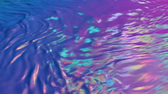 Abstract purple and blue liquid gradient background featuring holographic light refractions, iridescent prism effects, and fluid metallic ripples on a smooth textured surface.