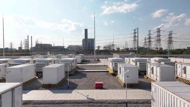 Large-scale energy storage power station with neatly arranged battery container units outdoors under clear sky