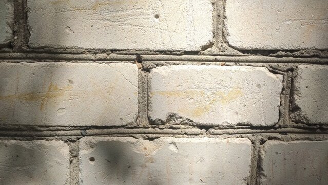 Shadowed White Masonry with soft diagonal light patterns falling across the blocks. Great for elegant urban backgrounds, subtle architectural details, and presentation templates.