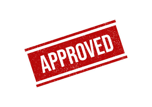 Red rubber stamp with the word approved on a textured surface