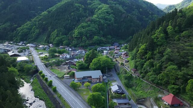 Aerial drone footage of Yuki Onsen hot spring village surrounded by mountains in Hiroshima