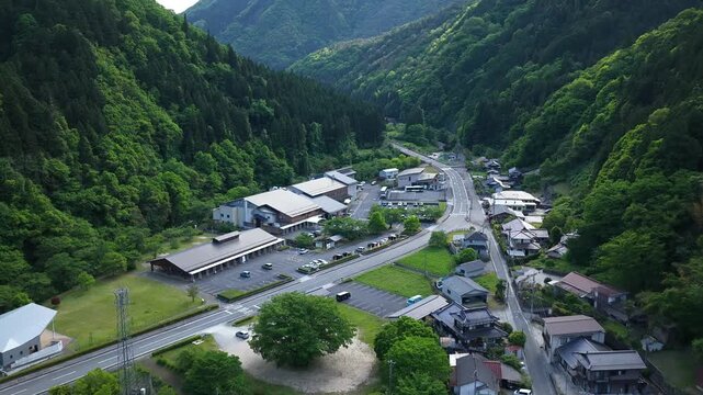 Aerial drone footage of Yuki Onsen hot spring town nestled in mountain valley, Hiroshima