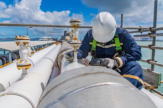 Male worker inspection and measurement thickness pipeline oil and gas at check record pipeline