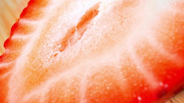 The inner structure of a strawberry is revealed through macro photography, symbolizing biological design, natural growth, scientific observation, sustainability and the complexity of living organisms.