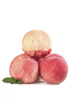 Fresh Ripe Peaches Stack with Peeled Fruit and Mint Leaf