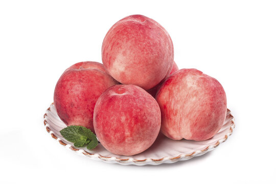 Fresh Red Peaches on White Plate with Mint Leaf
