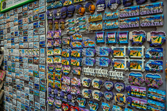 Colorful souvenir magnets featuring Croatia and Trogir landmarks displayed at a local gift shop