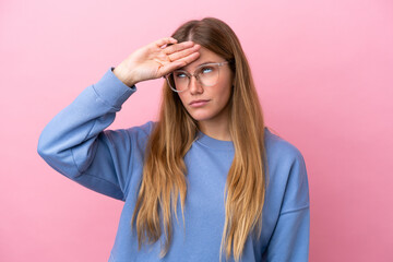 Fototapeta premium Young blonde woman isolated on pink background With glasses and tired