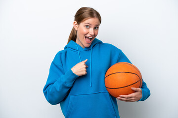 Young caucasian woman playing basketball isolated on white background with surprise facial...
