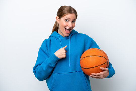 Young caucasian woman playing basketball isolated on white background with surprise facial expression