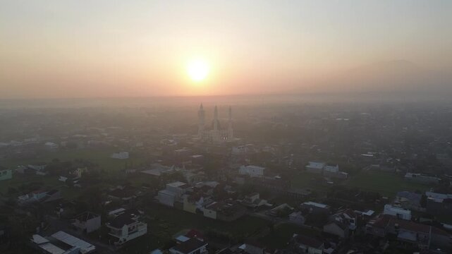 Aerial Sunrise View of Madaniyah Mosque and Mount Lawu in Karanganyar, Central Java, Indonesia