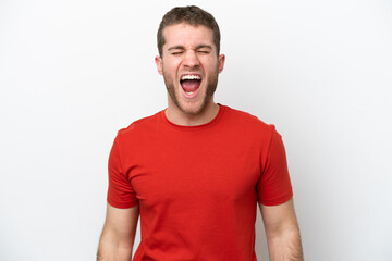 Obraz premium Young caucasian man isolated on white background shouting to the front with mouth wide open