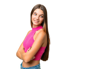 Obraz premium Teenager caucasian girl over isolated background with arms crossed and happy