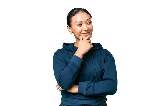 Young Uruguayan woman over isolated chroma key background looking to the side and smiling
