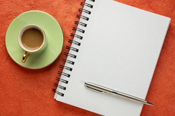 blank spiral notebook, flat lay with coffee on textured art paper
