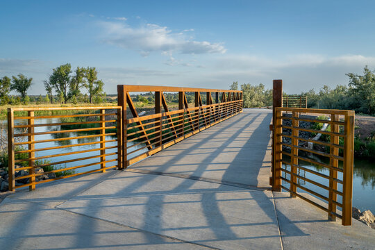 biking trail crossing water diversion canal - Poudre River Trail near Timnath in northern Colorado