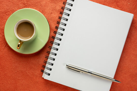 blank spiral notebook, flat lay with coffee on textured art paper