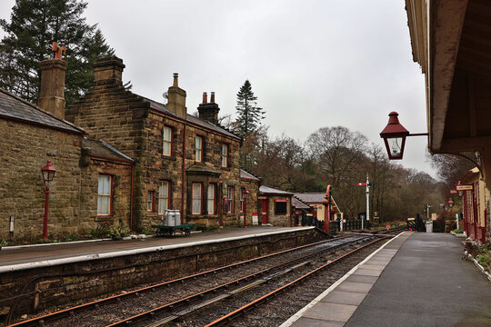 Gothland Station railway platform in Goathland, North Yorkshire; North Yorkshire Moors Railway historic stone train station buildings, retro red lamps, empty tacks, movie and TV filming location, UK
