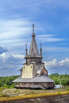 Wooden church of St Nicholas in Povenets, Russia front view. Traditional northern architecture, dark wood